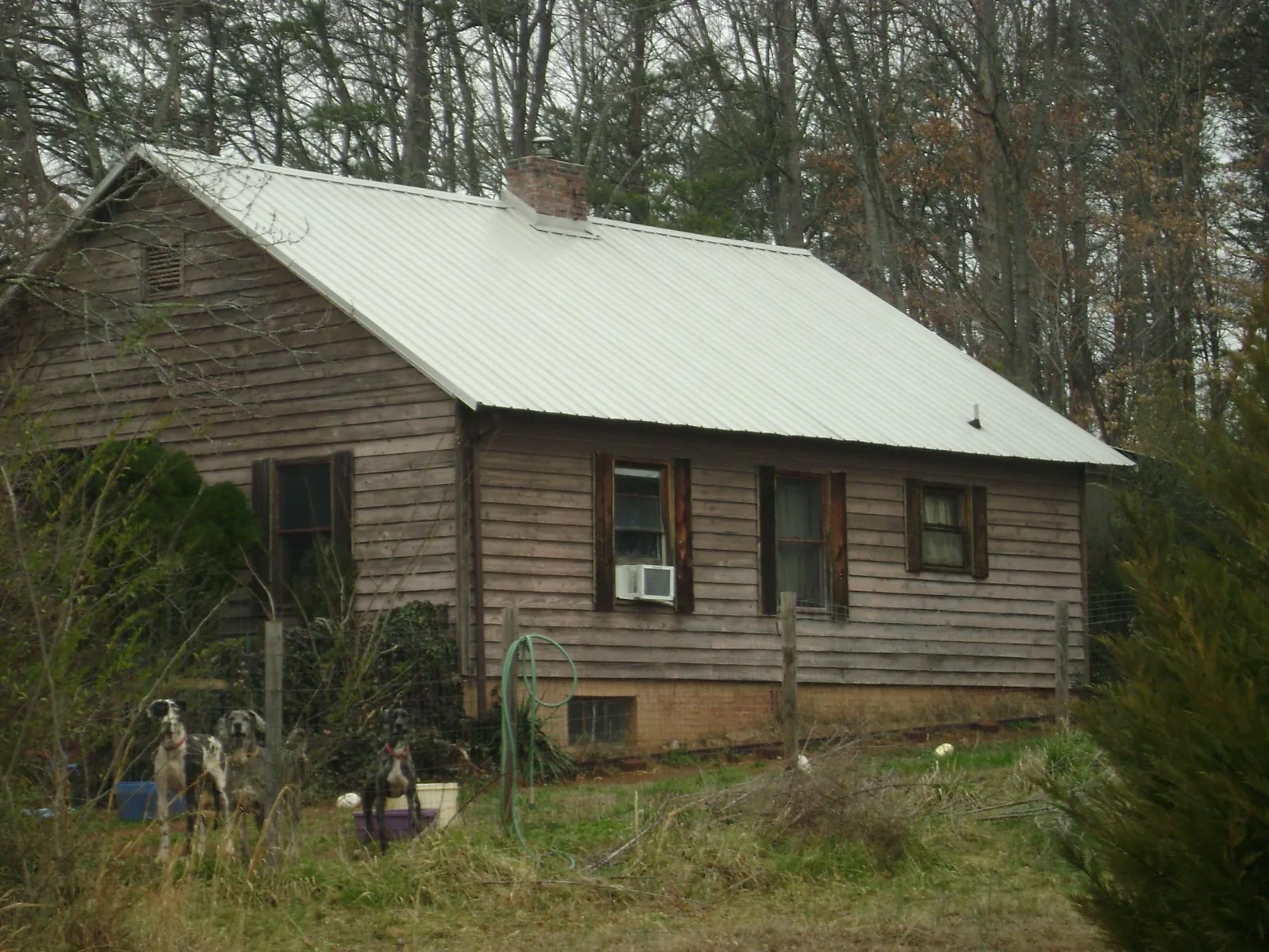 White metal roof on an old wood sided farmhouse, from a Asphalt Shingle Roof Repair job in Stewartsville